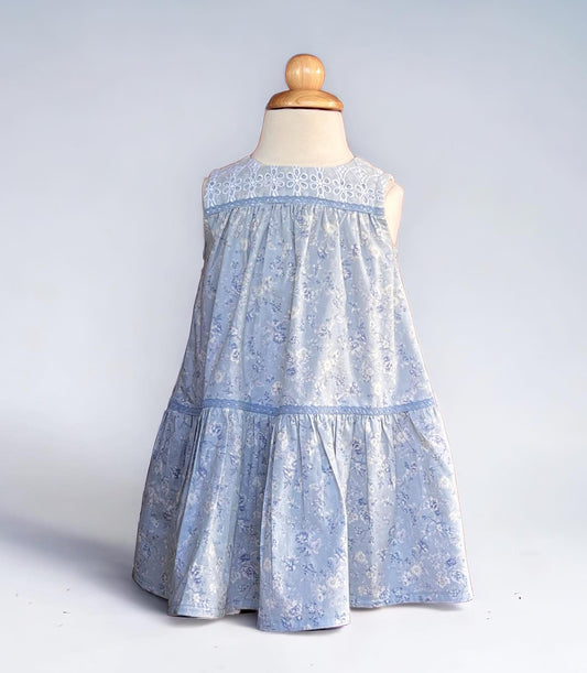 A delightful size 4T dress perfect for twirling. A lovely blue floral pattern and featuring a charming button-down back. Free Shipping.