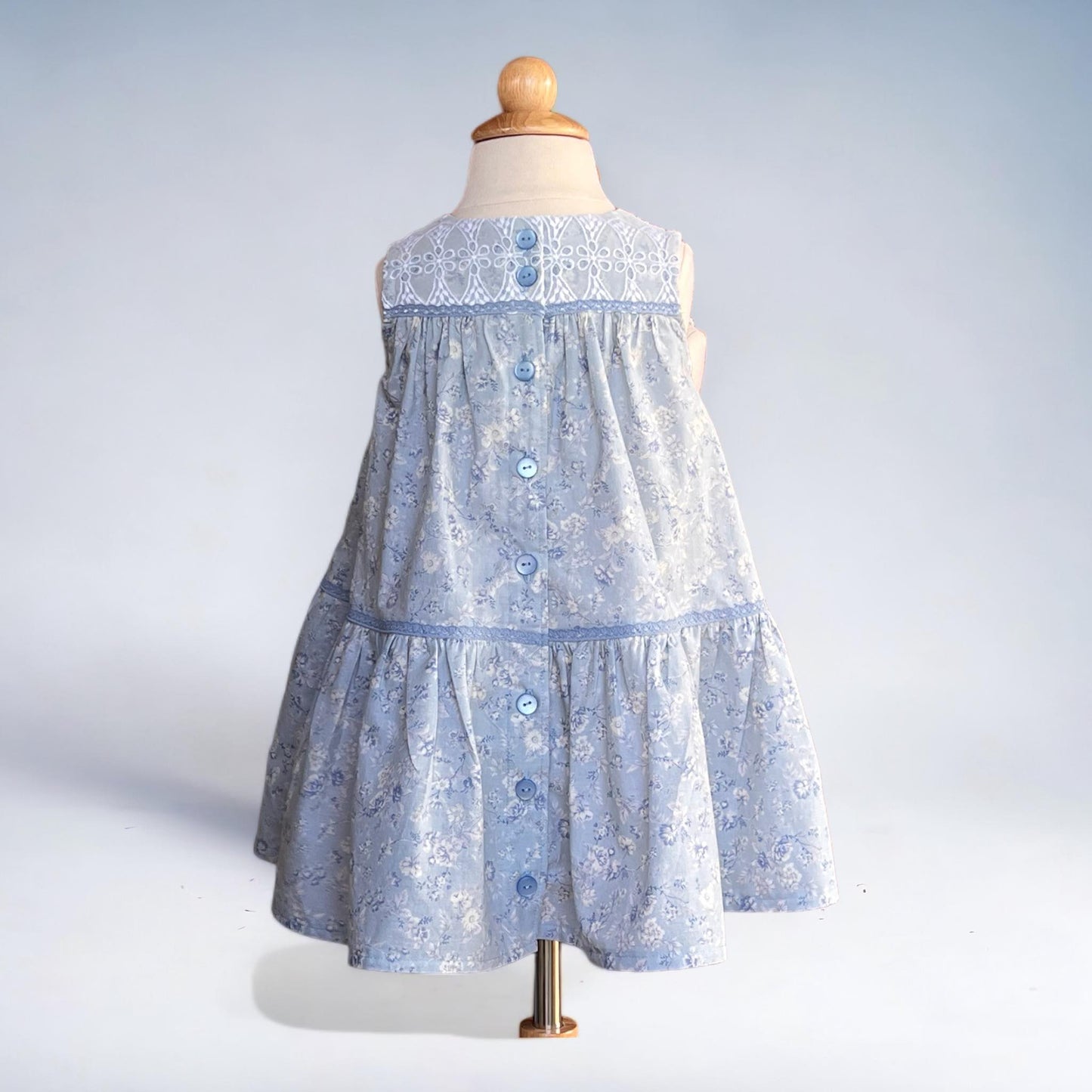 A delightful size 4T dress perfect for twirling. A lovely blue floral pattern and featuring a charming button-down back. Free Shipping.